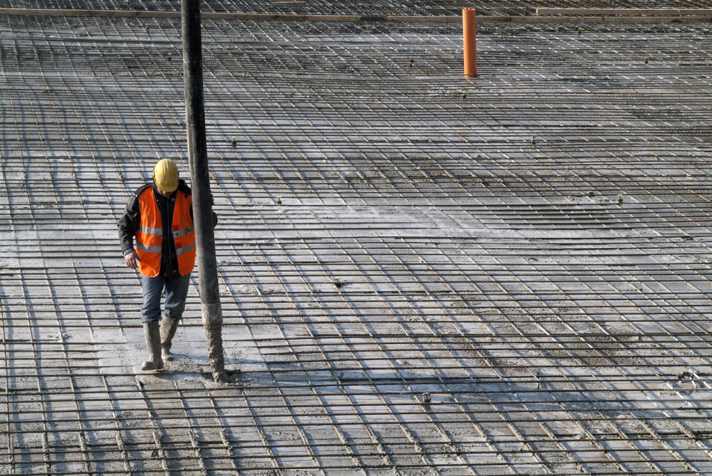 Concrete casting on Reinforcing Bar of floor in industrial Construction site
